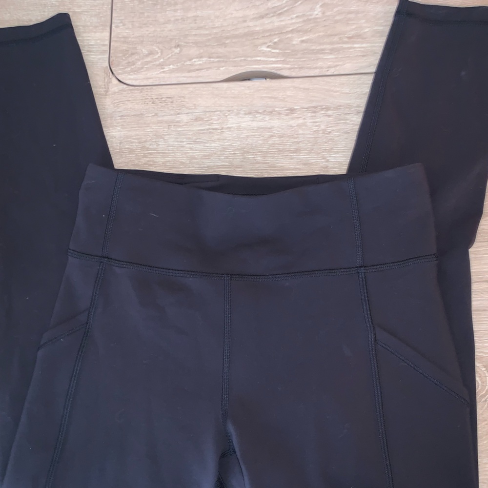 Black lululemon leggings with side pockets and a hidden waistband pocket
